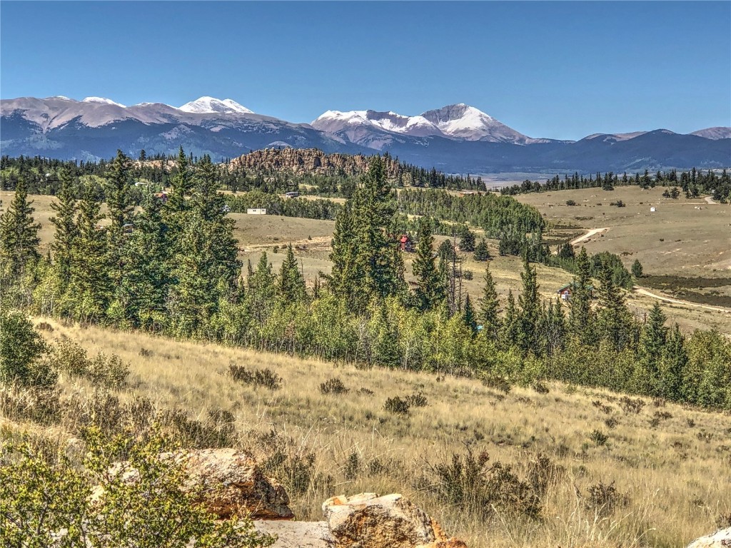 a view of mountain with sunset in background