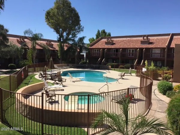 a view of a house with backyard and sitting area