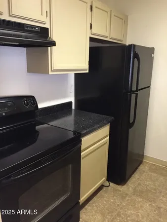 a kitchen with a sink and a refrigerator