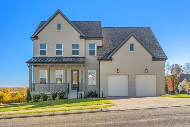 a view of a brick house with swimming pool in front of it