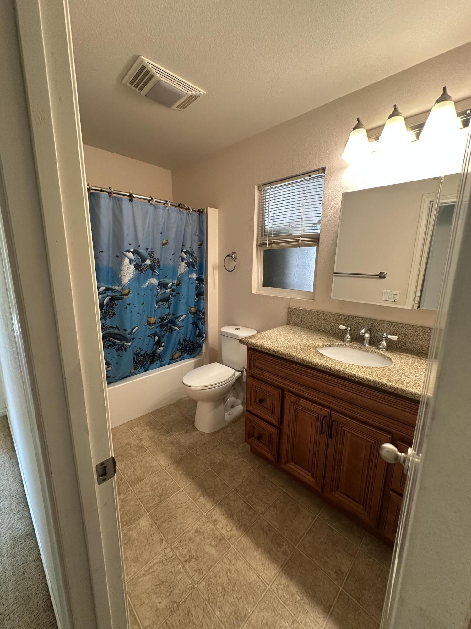 15786 El Centro Road Hesperia, CA 92345 - Photo 7 of 14 a spacious bathroom with a granite countertop sink toilet and shower