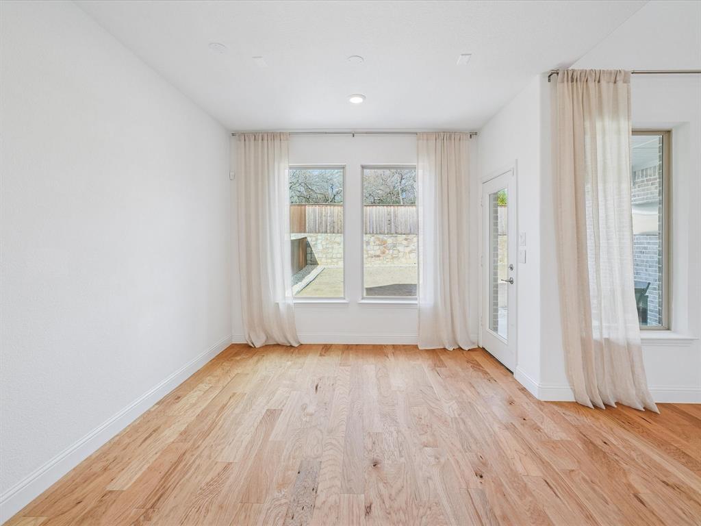 321 Fulton Street Oak Point, TX 75068 - Photo 14 of 36 an empty room with wooden floor and windows
