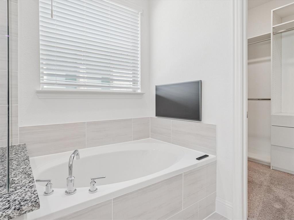 321 Fulton Street Oak Point, TX 75068 - Photo 19 of 36 a white bath tub sitting in a bathroom