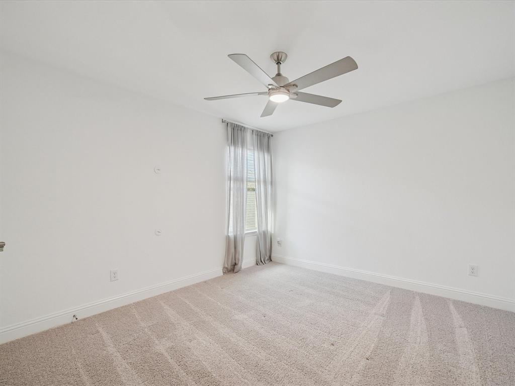 321 Fulton Street Oak Point, TX 75068 - Photo 24 of 36 an empty room with a window and a fan