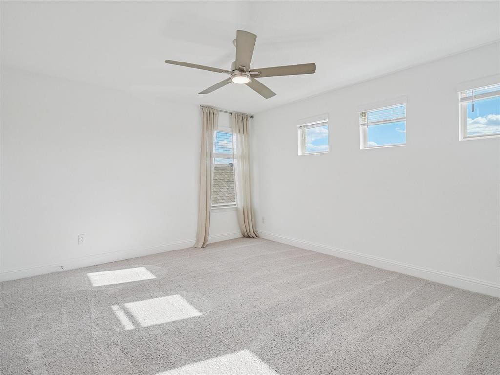 321 Fulton Street Oak Point, TX 75068 - Photo 26 of 36 an empty room with a ceiling fan and a window