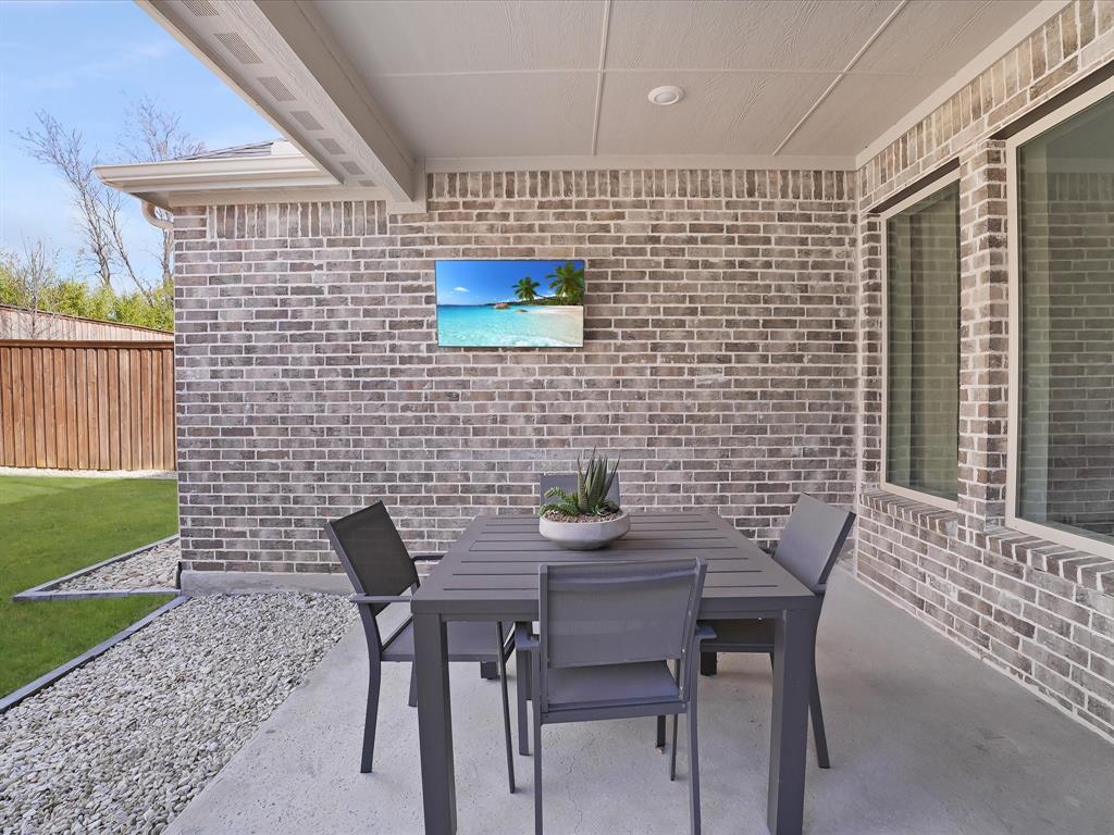 321 Fulton Street Oak Point, TX 75068 - Photo 31 of 36 a backyard of a house with table and chairs