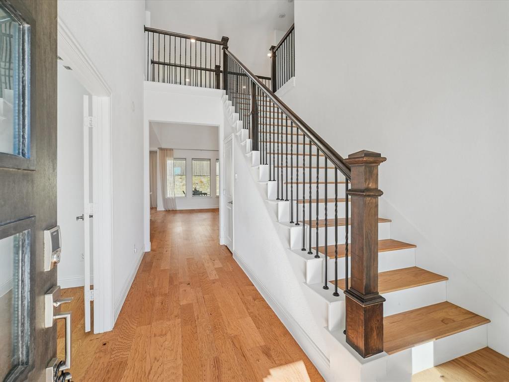 321 Fulton Street Oak Point, TX 75068 - Photo 6 of 36 a view of staircase with white walls and a window