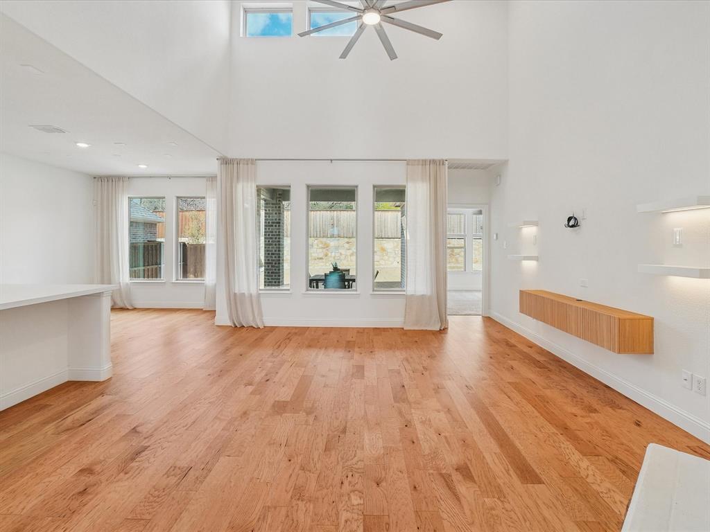 321 Fulton Street Oak Point, TX 75068 - Photo 7 of 36 a view of an empty room with wooden floor and a window