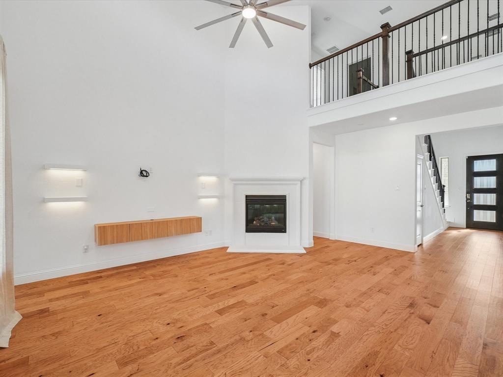 321 Fulton Street Oak Point, TX 75068 - Photo 9 of 36 a view of an empty room with a ceiling fan and window
