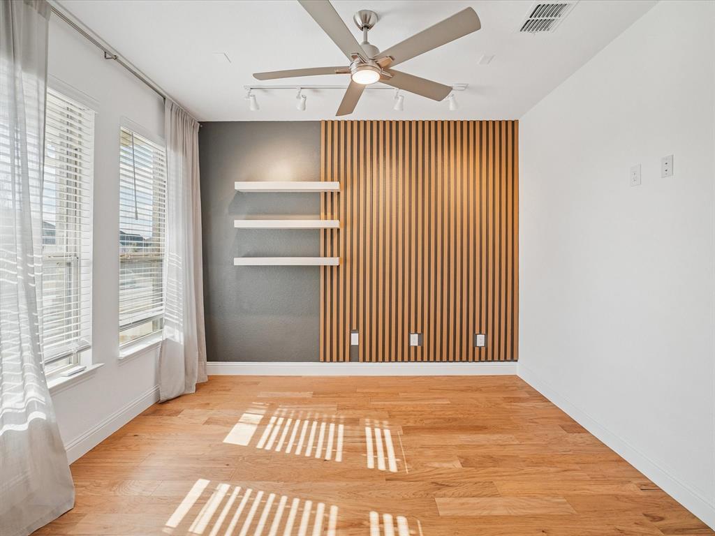 321 Fulton Street Oak Point, TX 75068 - Photo 10 of 36 a view of a room with wooden floor and a ceiling fan
