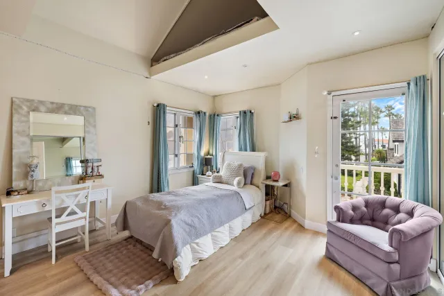 a bedroom with a bed couch and a window