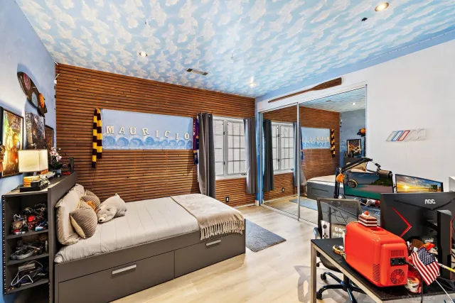 a bedroom with furniture and a large window