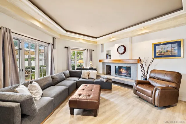 a living room with furniture a large window and a fireplace