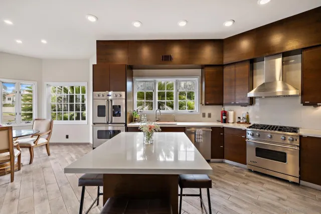 a kitchen with a table chairs sink and stove