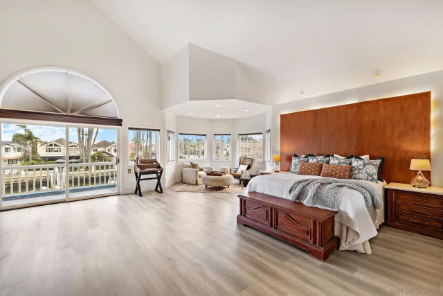 a spacious bedroom with a bed and a large window