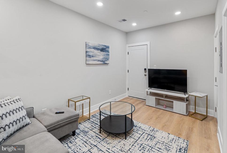 820 18th Street Northeast, Unit 102 Washington, DC 20002 - Photo 11 of 17 a living room with furniture and a flat screen tv