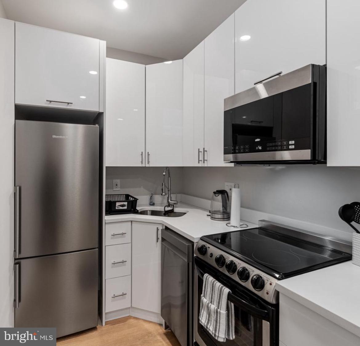 820 18th Street Northeast, Unit 102 Washington, DC 20002 - Photo 13 of 17 a kitchen with stainless steel appliances a refrigerator stove and microwave