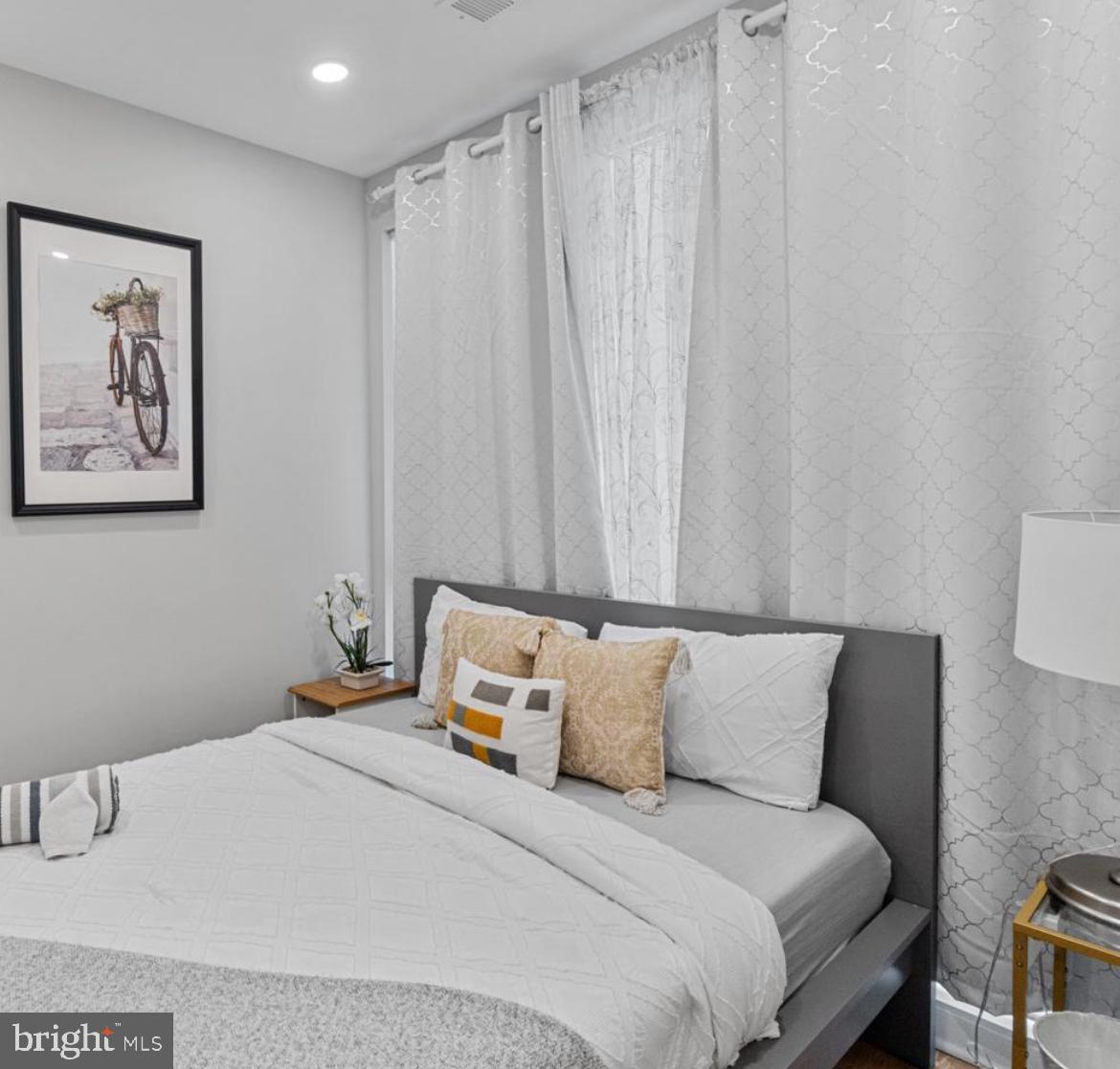 820 18th Street Northeast, Unit 102 Washington, DC 20002 - Photo 14 of 17 a bedroom with a bed and a painting on the wall