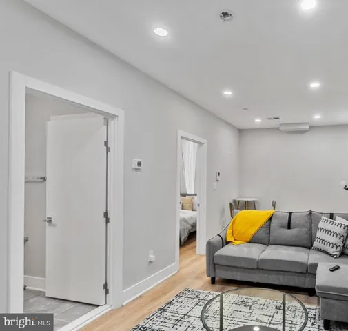 a living room with furniture and a walk in closet