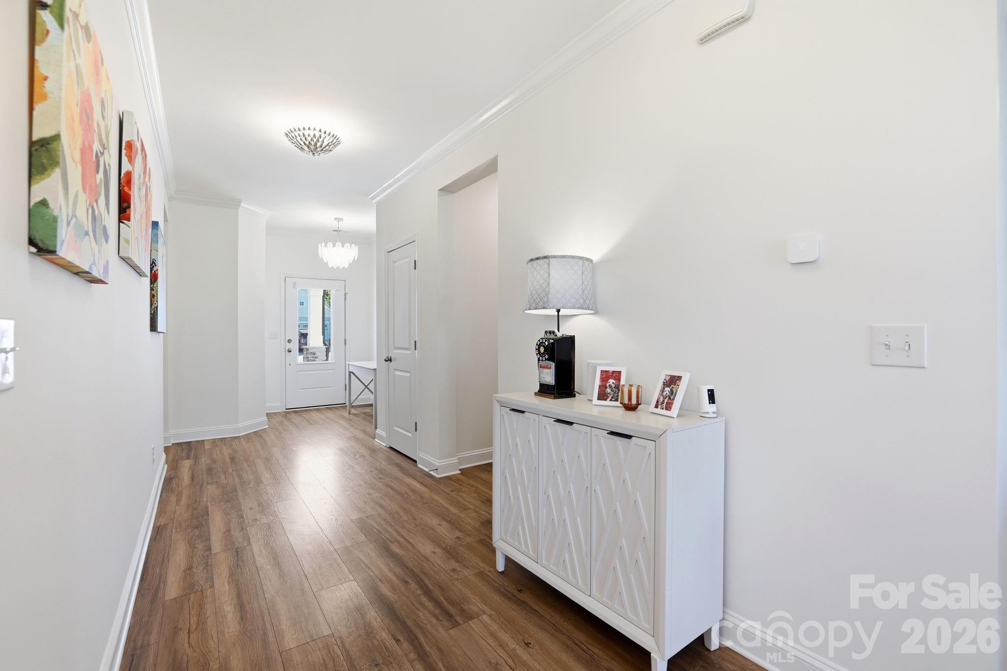 6038 Holland Street Fort Mill, SC 29707 - Photo 6 of 48 a view of a hallway with wooden floor and cabinet