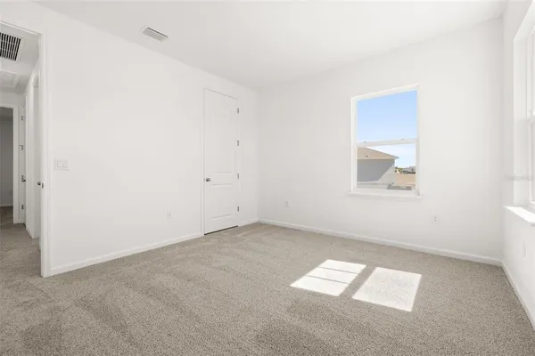 a view of cabinets and utility room with closet