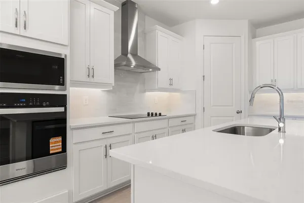 a kitchen with cabinets appliances and a sink