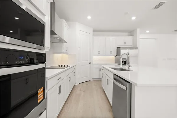 a kitchen with stainless steel appliances granite countertop a sink and cabinets