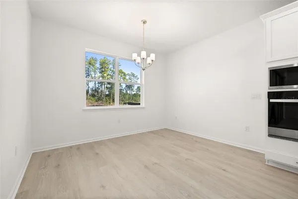 an empty room with windows and entrance