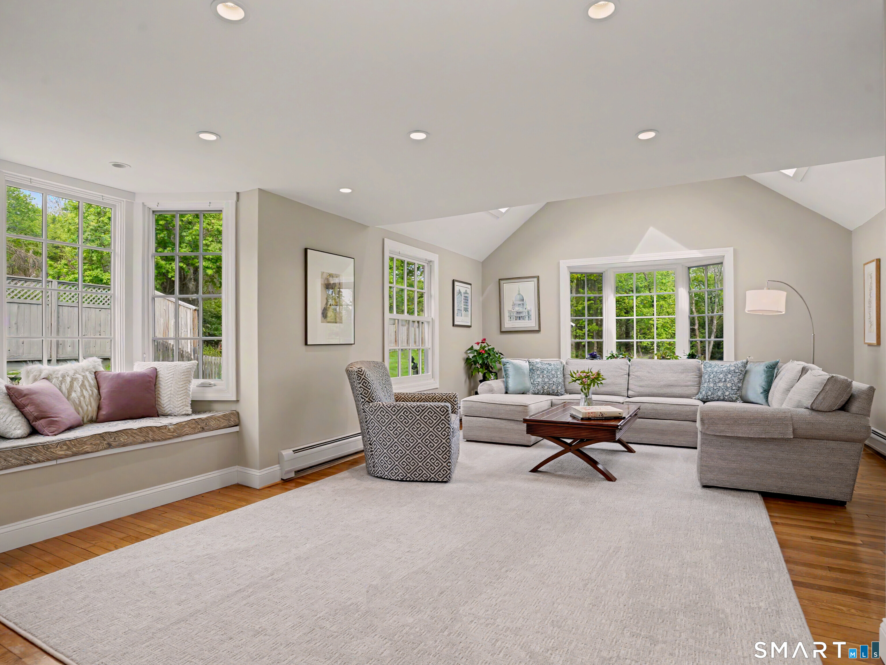 105 Ivy Hill Road Ridgefield, CT 06877 - Photo 6 of 39 The large living room has high ceilings, a window seat and stone fireplace.