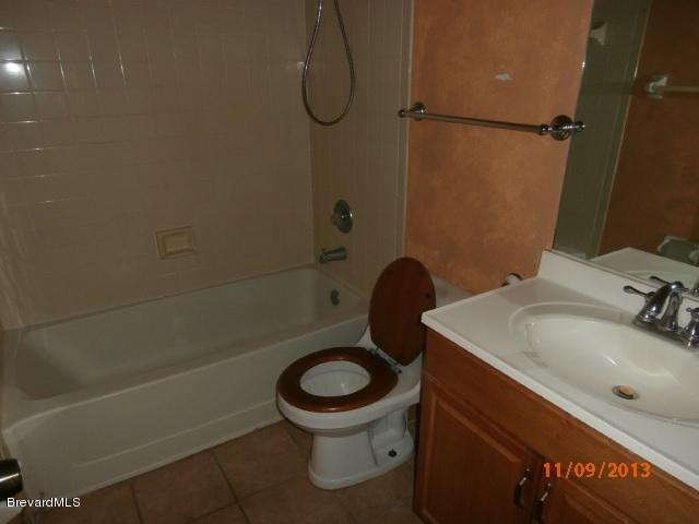 265 Benchor Road Northwest Palm Bay, FL 32907 - Photo 12 of 14 a bathroom with a sink a toilet and a shower