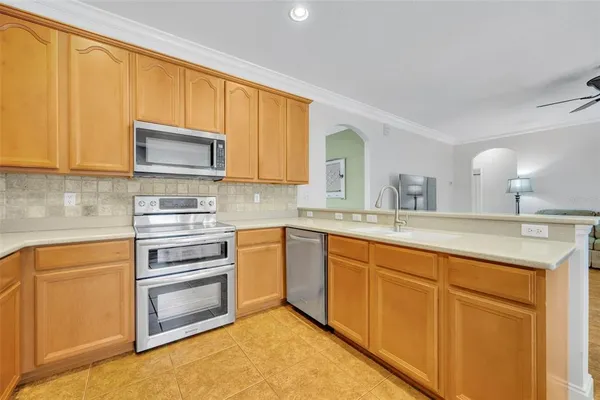 a kitchen with stainless steel appliances granite countertop a sink and cabinets