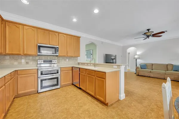 a large white kitchen with a large window