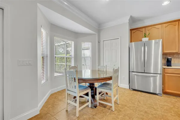 a living room with furniture and a view of kitchen