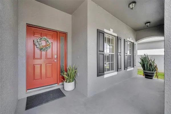 a view of backyard with green space and porch
