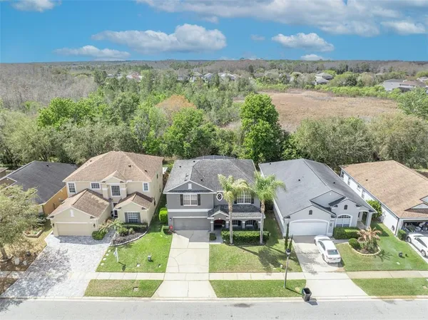 an aerial view of residential houses with outdoor space and ocean view