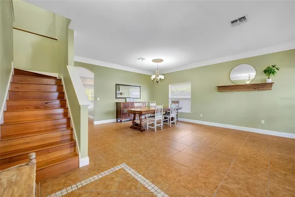 a view of a livingroom with furniture and stairs