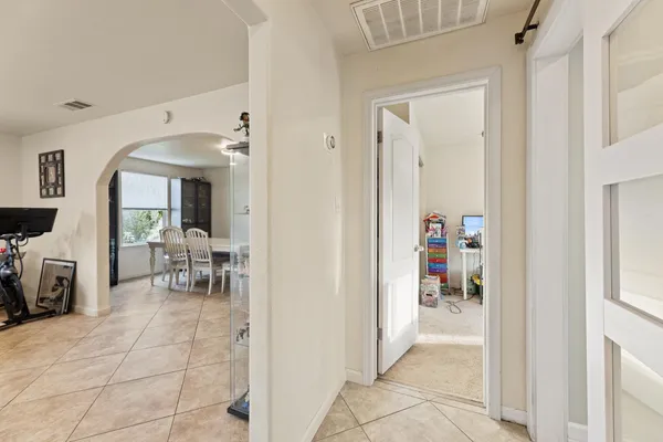 a view of a hallway with a livingroom and a dinning area