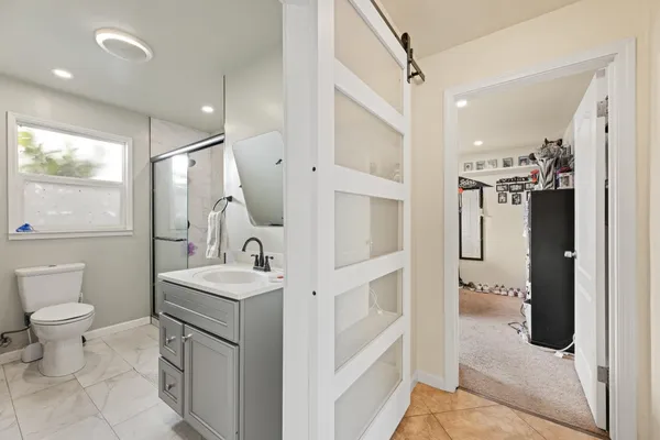 a bathroom with a sink a toilet and a mirror