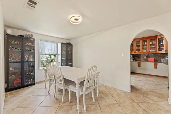a kitchen with stainless steel appliances granite countertop a refrigerator a sink dishwasher and wooden cabinets with wooden floor