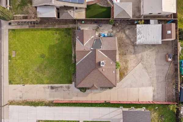 an aerial view of a house with a yard