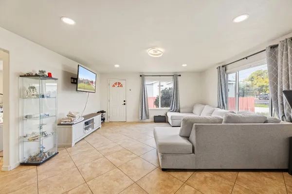 a living room with furniture and a flat screen tv