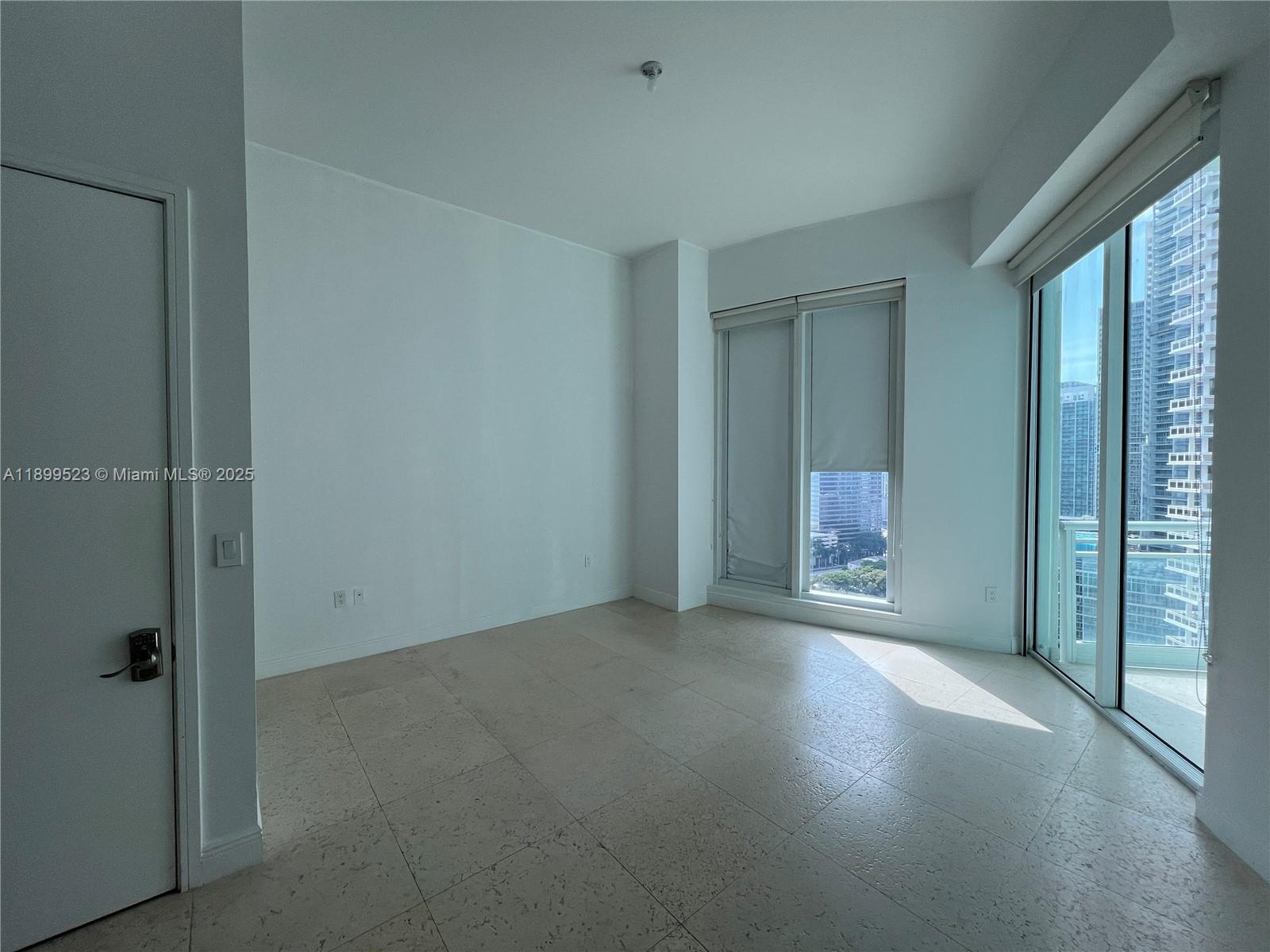 900 Brickell Key Boulevard, Unit 2205 Miami, FL 33131 - Photo 26 of 50 an empty room with windows