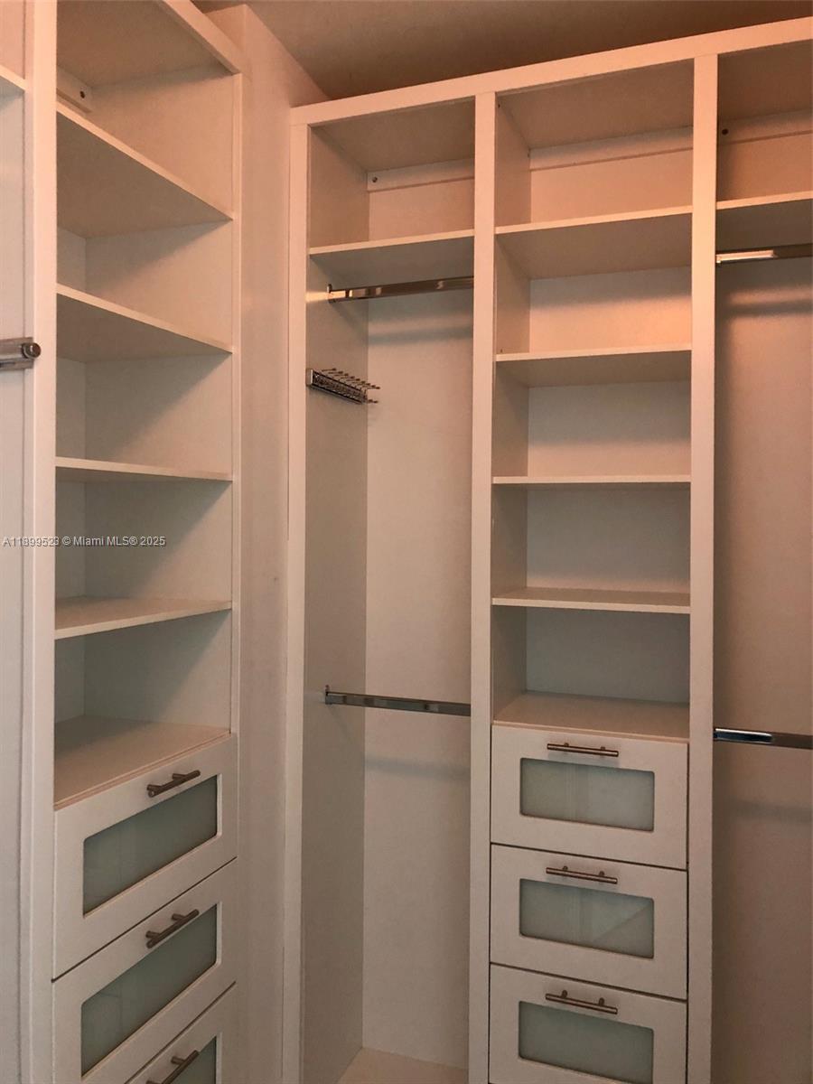 900 Brickell Key Boulevard, Unit 2205 Miami, FL 33131 - Photo 27 of 50 a view of walk in closet with empty racks