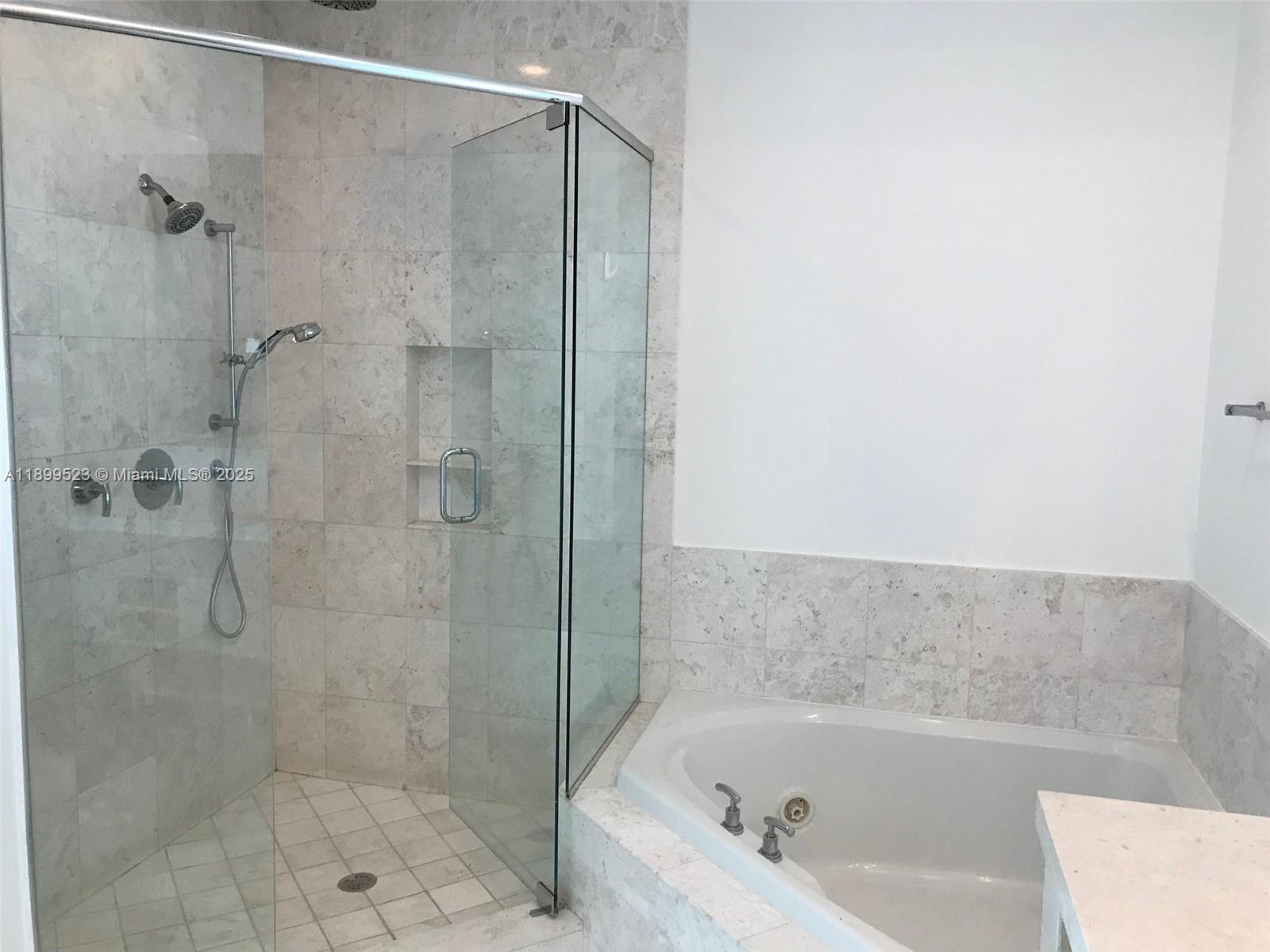 900 Brickell Key Boulevard, Unit 2205 Miami, FL 33131 - Photo 28 of 50 a bathroom with a bathtub and a shower