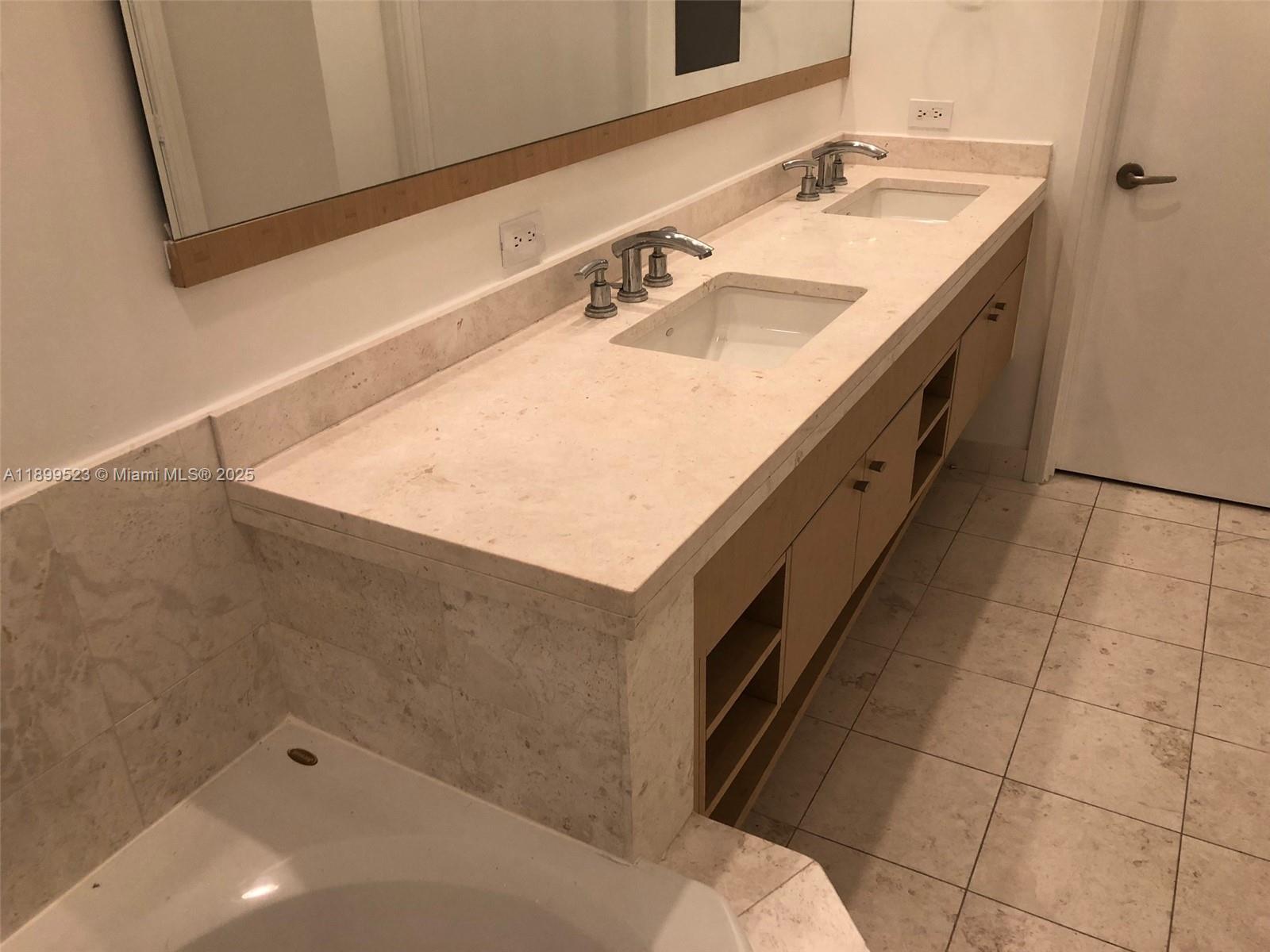 900 Brickell Key Boulevard, Unit 2205 Miami, FL 33131 - Photo 29 of 50 a bathroom with a sink and a mirror