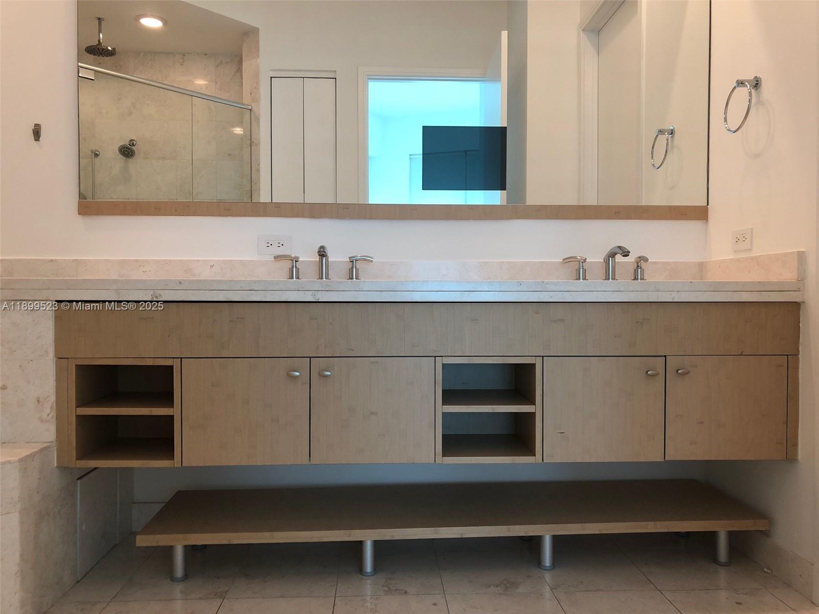 900 Brickell Key Boulevard, Unit 2205 Miami, FL 33131 - Photo 30 of 50 a bathroom with a sink and a mirror