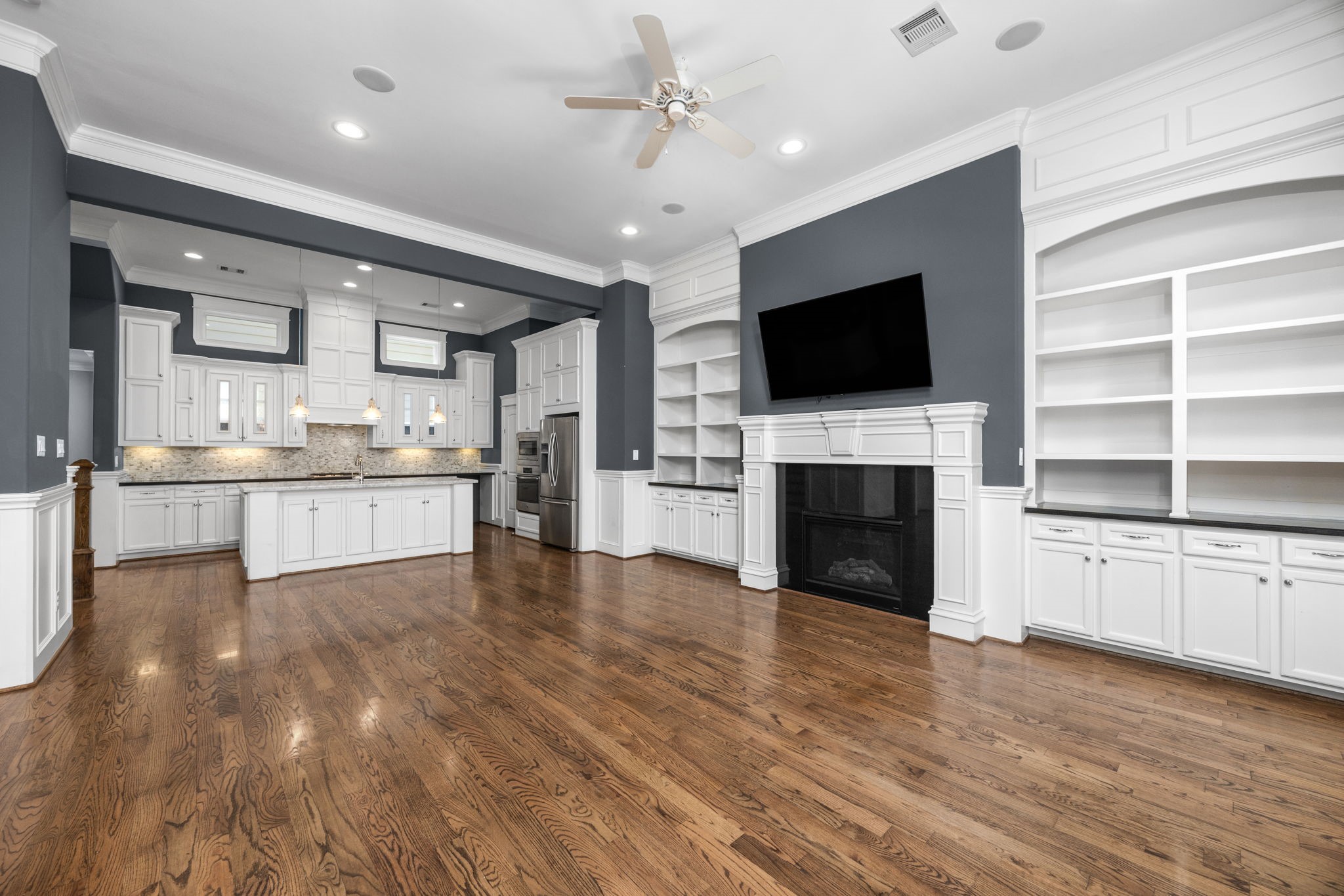 619 Rutland Street, Unit B Houston, TX 77007 - Photo 7 of 33 a view of a kitchen with a sink a kitchen a refrigerator and a fireplace