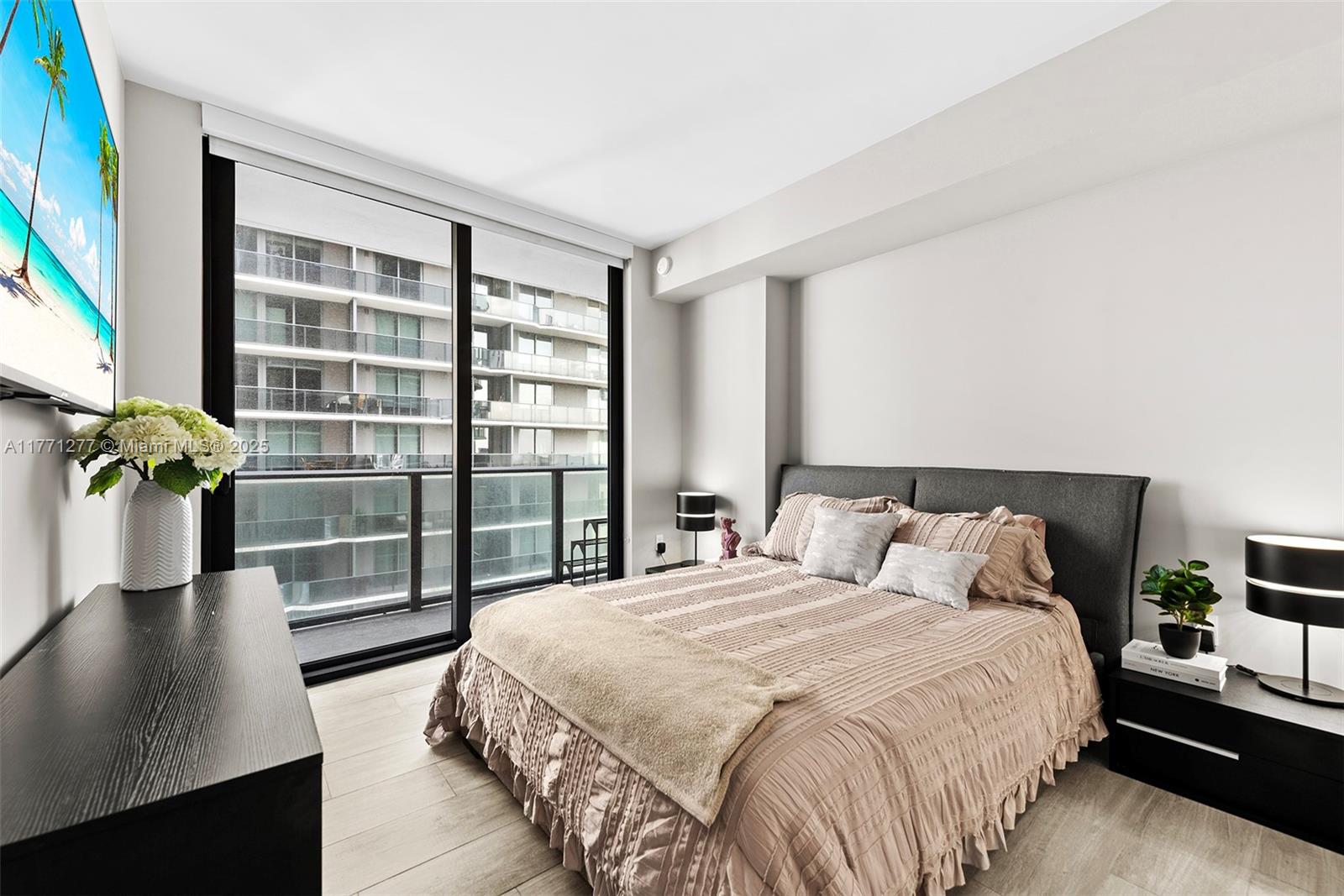 55 Southwest 9th Street, Unit 3601 Miami, FL 33130 - Photo 11 of 38 a bedroom with a balcony a bed and a potted plant