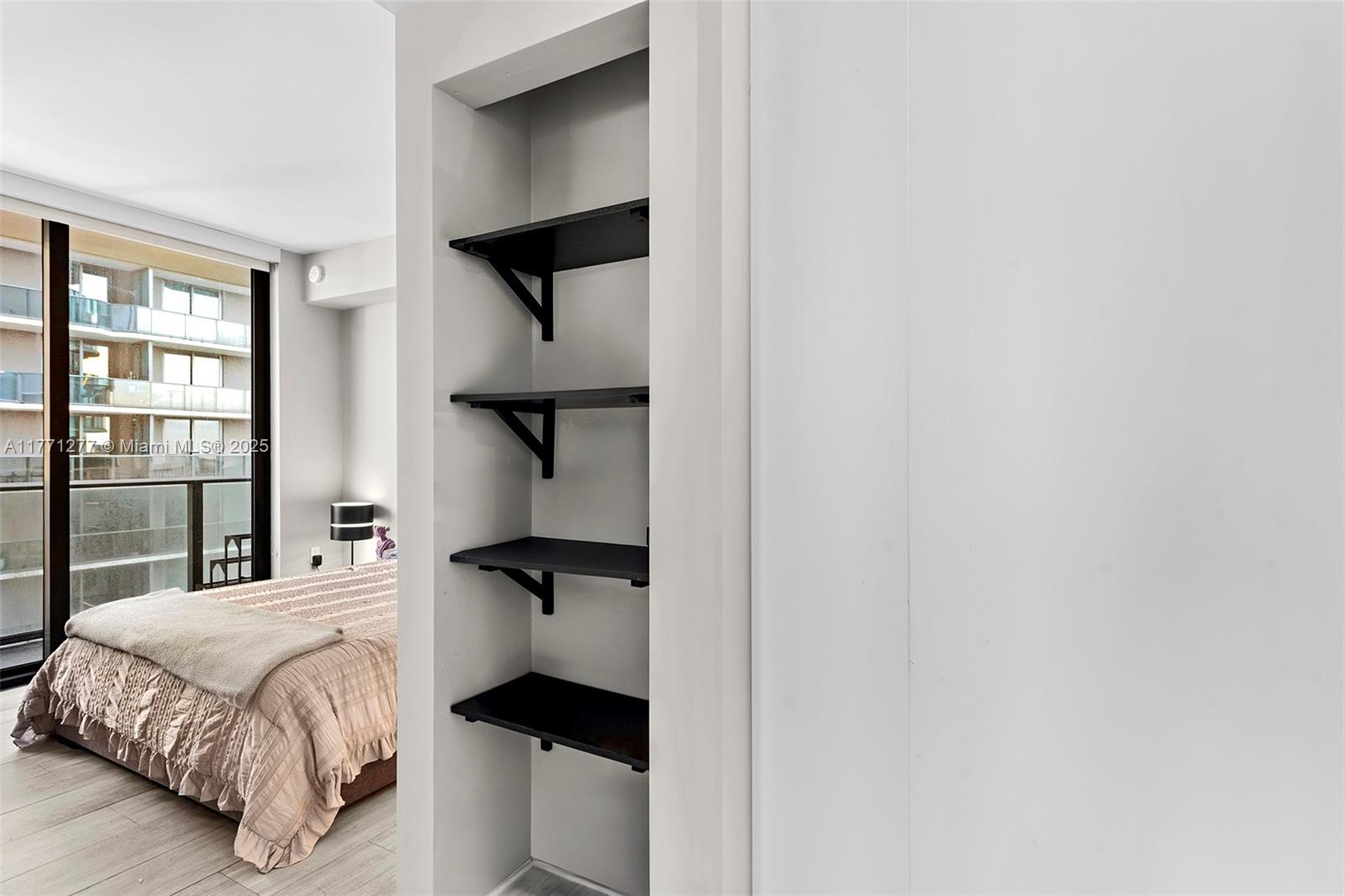 55 Southwest 9th Street, Unit 3601 Miami, FL 33130 - Photo 12 of 38 a bedroom with a bed and wooden floor