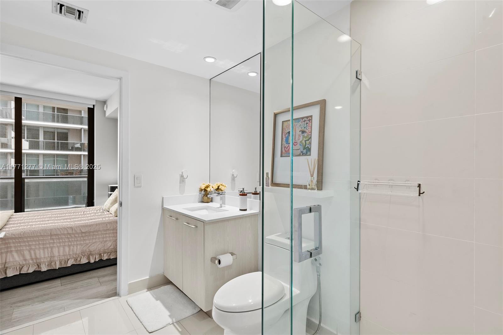 55 Southwest 9th Street, Unit 3601 Miami, FL 33130 - Photo 13 of 38 a bathroom with a sink toilet and shower